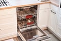 Empty Built-in dishwashers with opened door. Home appliance dishwasher machine in modern kitchen. White tone and clean Royalty Free Stock Photo