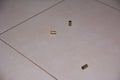 Empty bullet shells on the house floor. Bullet casings on the ceramic floor. selective focus Royalty Free Stock Photo