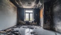 Empty burned room with window. Damaged apartment after house fire, charred walls and ceiling