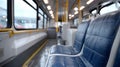Empty bus interior with blue seats and yellow poles. Royalty Free Stock Photo