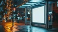 Empty bus stop at night in urban area with blank advertisement board Royalty Free Stock Photo
