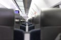 An empty cabin of the aeroexpress train without passengers. Soft seats in a row with leather headrests. Public place Royalty Free Stock Photo