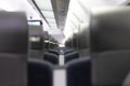 An empty cabin of the aeroexpress train without passengers. Soft seats in a row with leather headrests. Public place. Selective fo Royalty Free Stock Photo