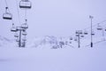 Empty cable cars for skiers in the snow-capped mountains