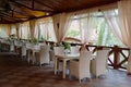 Empty cafe with rattan wicker armchairs and tables on summer garden terrace outdoor. Royalty Free Stock Photo