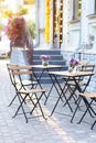 Empty cafe with terrace with tables and chairs. Street exterior of  restaurant. Flowers in vase on table. Furniture for coffee sho Royalty Free Stock Photo