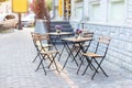 Empty cafe with terrace with tables and chairs. Street exterior of  restaurant. Flowers in vase on table. Furniture for coffee sho Royalty Free Stock Photo