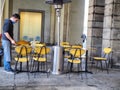 Empty cafe terrace tables on downtown sidewalk