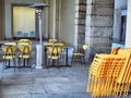 Empty cafe terrace tables on downtown sidewalk