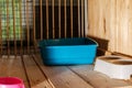 An empty cage in an animal shelter. Inside it is a Blue tray and a feed bowl.