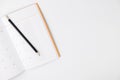 Empty Calendar book and pencil on white isolated background, top view