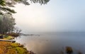 Empty campfire in early morning fog on a lake near Ottawa, Ontario. Royalty Free Stock Photo