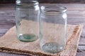 Empty canning jars await use on a wooden table Royalty Free Stock Photo