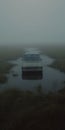 Empty Car In Foggy Marsh: A Cinematic Still Shot