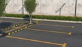Empty car parking without cars. Parking spaces, sidewalk for pedestrians with flower bed. Royalty Free Stock Photo