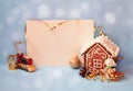 Empty card for your text, little gingerbread house and christmas decorations locomotive,  snowman and ball on blue background Royalty Free Stock Photo