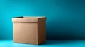 Empty cardboard box on teal background with copy space. Royalty Free Stock Photo