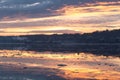 Empty cargo boat moving along the St. Lawrence River during a pink and orange winter sunrise Royalty Free Stock Photo