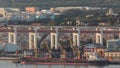 Empty cargo ship waiting for loading in port aerial timelapse. Lots of cranes and containers in background. Lisbon Royalty Free Stock Photo