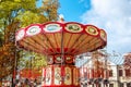 Empty Carousel Merry-Go-Round With Seats Suspended On Chains Wi