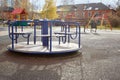 empty carousel on a playground on an autumn sunny day Royalty Free Stock Photo