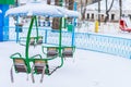Empty carousels for children covered with snow in winter. Background with selective focus and copy space