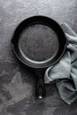 Empty cast iron frying pan on dark grey culinary background, view from above Royalty Free Stock Photo