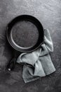 Empty cast iron frying pan on dark grey culinary background, view from above Royalty Free Stock Photo