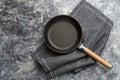 Empty cast iron frying pan on dark grey culinary background, view from above Royalty Free Stock Photo