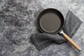 Empty cast iron frying pan on dark grey culinary background, view from above Royalty Free Stock Photo