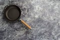 Empty cast iron frying pan on dark grey culinary background, view from above Royalty Free Stock Photo