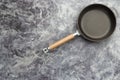 Empty cast iron frying pan on dark grey culinary background, view from above Royalty Free Stock Photo