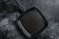 Empty cast-iron grill pan for cooking on rustic towel. Black background. Top view. Copy space Royalty Free Stock Photo