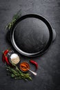 Empty cast-iron pan with ingredients for cooking on black background Royalty Free Stock Photo