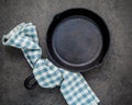 Empty cast iron skillet frying pan flat lay on dark stone background with copy space . Royalty Free Stock Photo