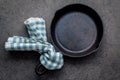 Empty cast iron skillet frying pan flat lay on dark stone background with copy space .