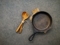 Empty cast iron skillet frying pan flat lay on dark stone background with copy space