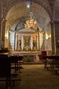 Empty catholic cathedral. Church altar with chandelier, saint sculptures and benches. Church interior with altar. Royalty Free Stock Photo