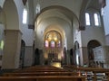 Empty Catholic church with only one praying person