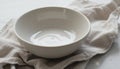 Empty Ceramic Bowl Resting on a Clean Linen Cloth in a Bright Kitchen Setting Royalty Free Stock Photo