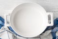 Empty ceramic pan on the white wooden table top view Royalty Free Stock Photo