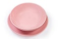 Empty ceramic pink bowl on flat plate on white background