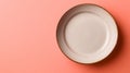 Empty ceramic plate on pink background, minimalist kitchenware. Royalty Free Stock Photo