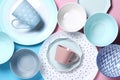 Empty ceramic tableware. Ceramic plates and cups on pink and blue background. Set of different modern white and blue plates,bowls