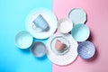 Empty ceramic tableware. Ceramic plates and cups on pink and blue background. Set of different modern white and blue plates,bowls