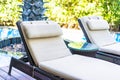 Empty chair deck lounge around swimming pool in hotel resort Royalty Free Stock Photo