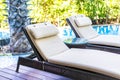 Empty chair deck lounge around swimming pool in hotel resort Royalty Free Stock Photo