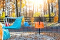 Empty chair multicolored colorful chain swing carousel at old vintage retro entertainment amusement park autumn sunset Royalty Free Stock Photo