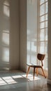 An empty chair in a quiet, sunlit room with a single window. Clean, The frame is dominated by the simplicity and abstract geometry Royalty Free Stock Photo