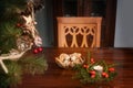 Empty chair at a table with burning candle, christmas decoration and gingerbread cookies, lonely holidays during coronavirus and Royalty Free Stock Photo